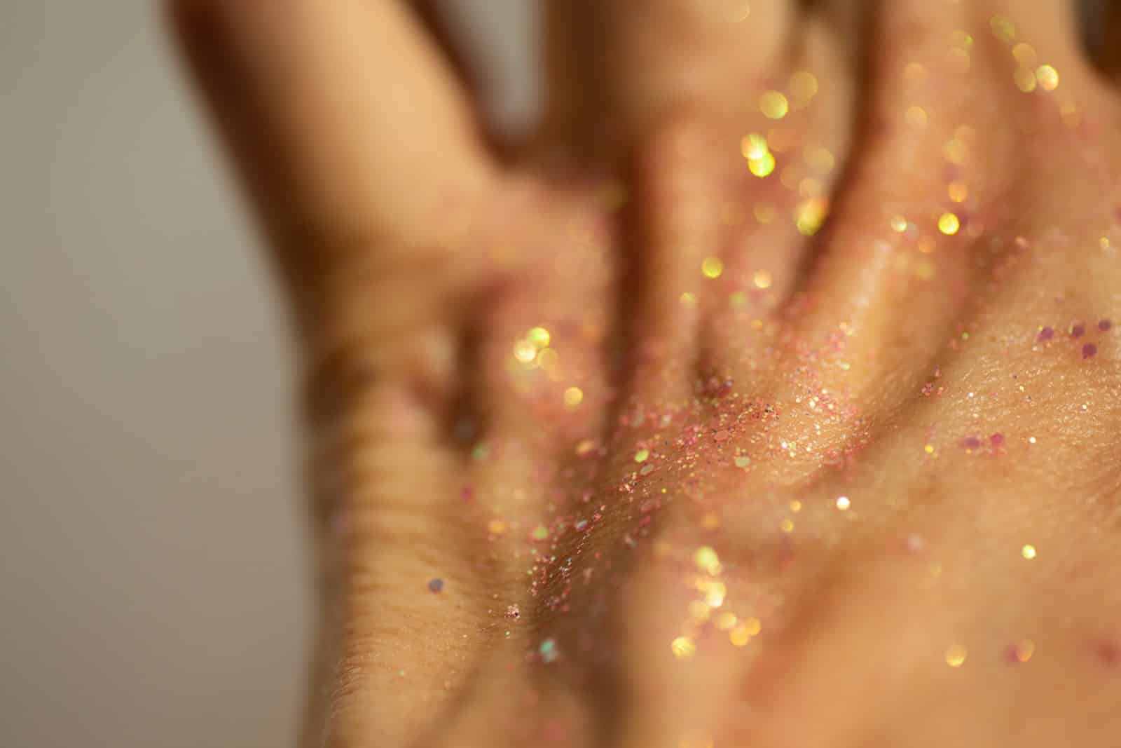 Close-up of a hand covered in glitter